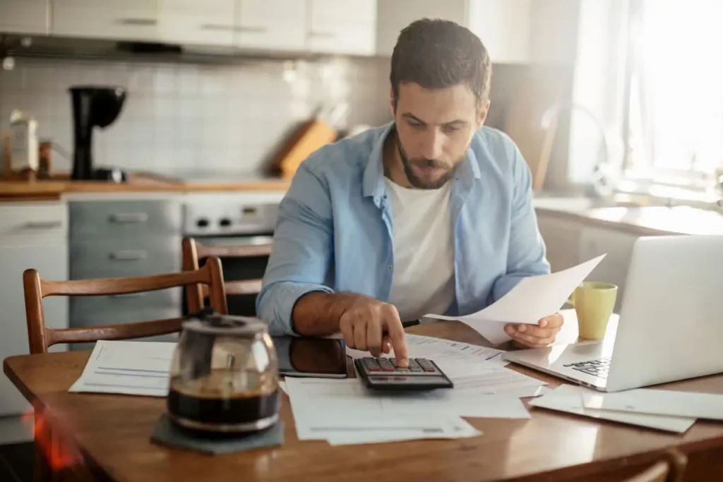 Persona calculando presupuesto de contingencia para cubrir gastos inesperados en los costos de construcción